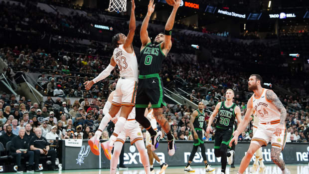 Dec 31, 2023; San Antonio, Texas, USA; Boston Celtics forward Jayson Tatum (0) shoots over San Antonio Spurs guard Tre Jones (33) in the first half at Frost Bank Center.